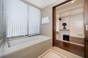 a bathroom with a bath tub and a window at Luxury 5 bed Laguna Park no Pool in Bang Tao Beach +57 photos