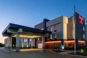 a hotel with a parking lot in front of it at Hampton Inn Owensboro in Owensboro