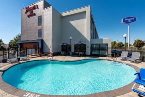 a large swimming pool in front of a hotel at Hampton Inn Owensboro in Owensboro