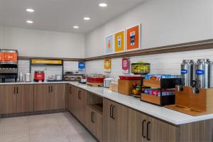 a large kitchen with wooden cabinets in a store at Hampton Inn Owensboro in Owensboro