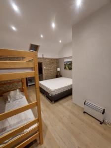 a bedroom with a bunk bed and a bunk ladder at L'Ecole in Dinant