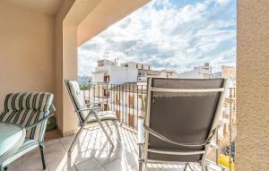 a balcony with chairs and a view of the city at Atico Roger De Flor in Port de Pollensa