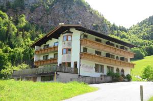 a large building on the side of a mountain at Gasthof Appartement`s Staffnerhof in Kössen