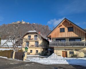 a house with a wooden roof in the snow at Sonnhof in Villach
