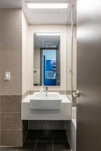 a bathroom with a sink and a mirror at Nampo Stay 99 in Busan +52 photos
