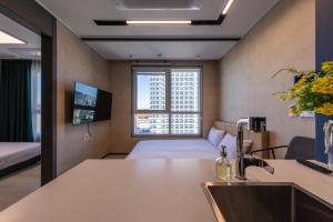 a hotel room with a bed and a sink at Nampo Stay 99 in Busan