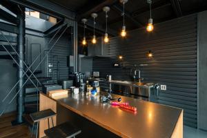 a large kitchen with a large counter in a room at Yokosuka Sky Grey -横須賀のビーチフロントベース- in Yokosuka +19 photos