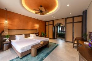 a bedroom with a bed and a ceiling fan at Emerald Garden Retreat in Phú Quốc +69 photos