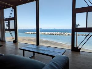 a living room with a view of the ocean at Yokosuka Sky Grey -横須賀のビーチフロントベース- in Yokosuka