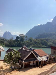 a group of buildings next to a body of water at Heuan kuuma in Nongkhiaw +13 photos