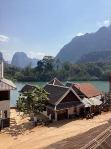 a group of buildings next to a body of water at Heuan kuuma in Nongkhiaw