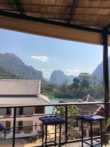a balcony with a view of a river and mountains at Heuan kuuma in Nongkhiaw