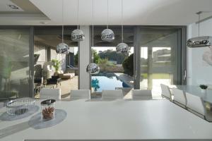 a dining room with a white table and white chairs at S Villa Place נהריה in Nahariyya