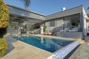 a swimming pool in front of a house at S Villa Place נהריה in Nahariyya