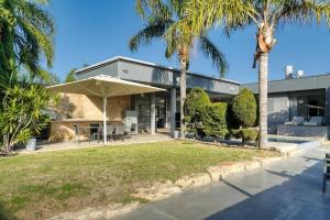 a house with a table and an umbrella at S Villa Place נהריה in Nahariyya