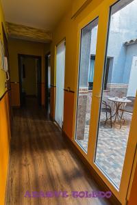 a hallway with sliding glass doors and a patio at Apartamentos Adarve Toledo in Toledo