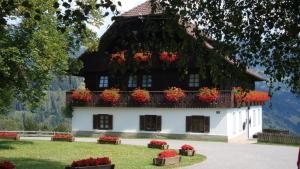 a house with flower boxes on the top of it at Ferienhaus Birkenhof in Afritz