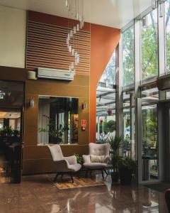 a lobby with chairs and a staircase in a building at Diament in Nowa Ruda