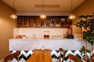a kitchen with a counter and a wooden table at Jade moon in Dali