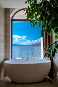 a bath tub in a bathroom with a large window at Jade moon in Dali +36 photos