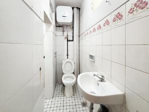 a bathroom with a toilet and a sink at RedDoorz Plus near Brawijaya Museum in Malang +23 photos