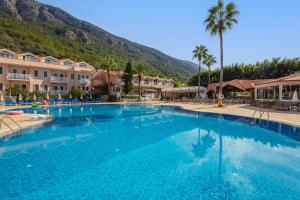 a large swimming pool in front of a resort at Ölüdeniz Turquoise Hotel - All Inclusive in Oludeniz
