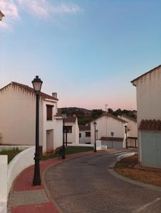 a street with a street light on a road at El Rinconcito in El Ronquillo