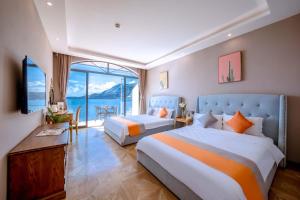 a hotel room with two beds and a balcony at Jade moon in Dali