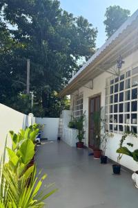 a white building with plants in front of it at A Modern 2BHK Private Villa in Vagator - Valenades in Vagator