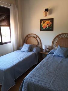 a bedroom with two beds and a window at El Rinconcito in El Ronquillo +47 photos