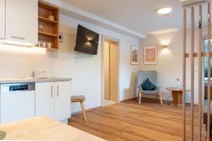a kitchen and living room with a table and a chair at Karwendelnest in Maurach +2 photos