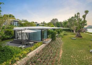 a house with a view of a yard at Mont Du Kwai Resort in Ban Yang (2)