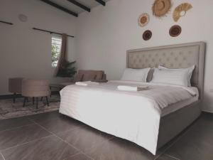 a bedroom with a large white bed and a living room at Sanyan Retreat in Jeram +40 photos