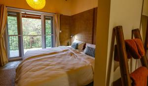 a bedroom with a large bed with a window at Resort Vishuddhialaya Pvt Ltd in Dhulikhel