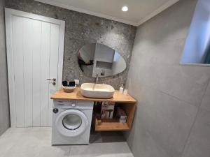 a bathroom with a sink and a mirror at Akti luxury aparts in Frý