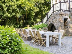 a white table and chairs sitting in a garden at Beautiful castle in Spa wit garden in Spa