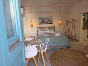 a bedroom with a bed and a table and chairs at Akti luxury aparts in Frý