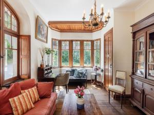 a living room with a couch and a table at Beautiful castle in Spa wit garden in Spa +32 photos