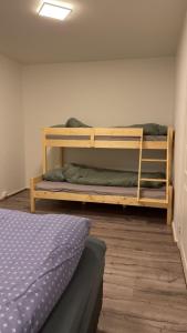 a bedroom with two bunk beds and a bed at Kirkenes down town apartments in Kirkenes