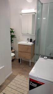 a bathroom with a sink and a mirror at Kirkenes down town apartments in Kirkenes +20 photos