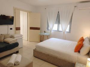 a bedroom with a large bed and a couch at Orange City Center in Tirana +22 photos