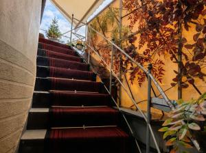 a staircase in a building with red and black seats at Orange City Center in Tirana