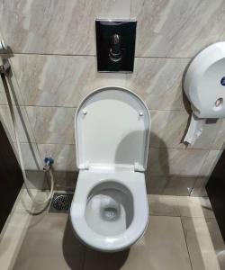 a bathroom with a toilet with a soap dispenser at MaMa ShuShu Homestay in Sapa