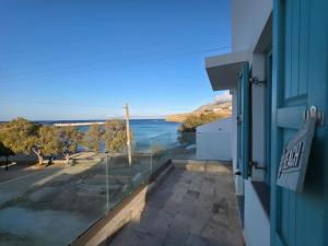 a view of the ocean from the balcony of a house at Akti luxury aparts in Frý