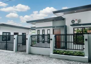a house with a gate in front of it at Casa De Una Tagaytay in Galicias