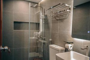 a bathroom with a shower and a toilet and a sink at Casa De Una Tagaytay in Galicias
