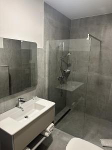 a bathroom with a sink and a shower at Hotel Johannisberg Bad Homburg in Bad Homburg vor der Höhe