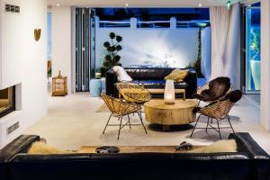 a living room with a couch and chairs and a table at Sea Sense Boutique Villa & Relax Zone in Sozopol