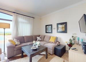 a living room with a couch and a table at Villa Olive View in Kyrenia