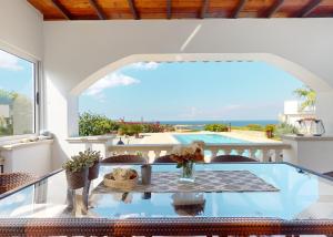 a dining room with a table and a view of the ocean at Villa Olive View in Kyrenia